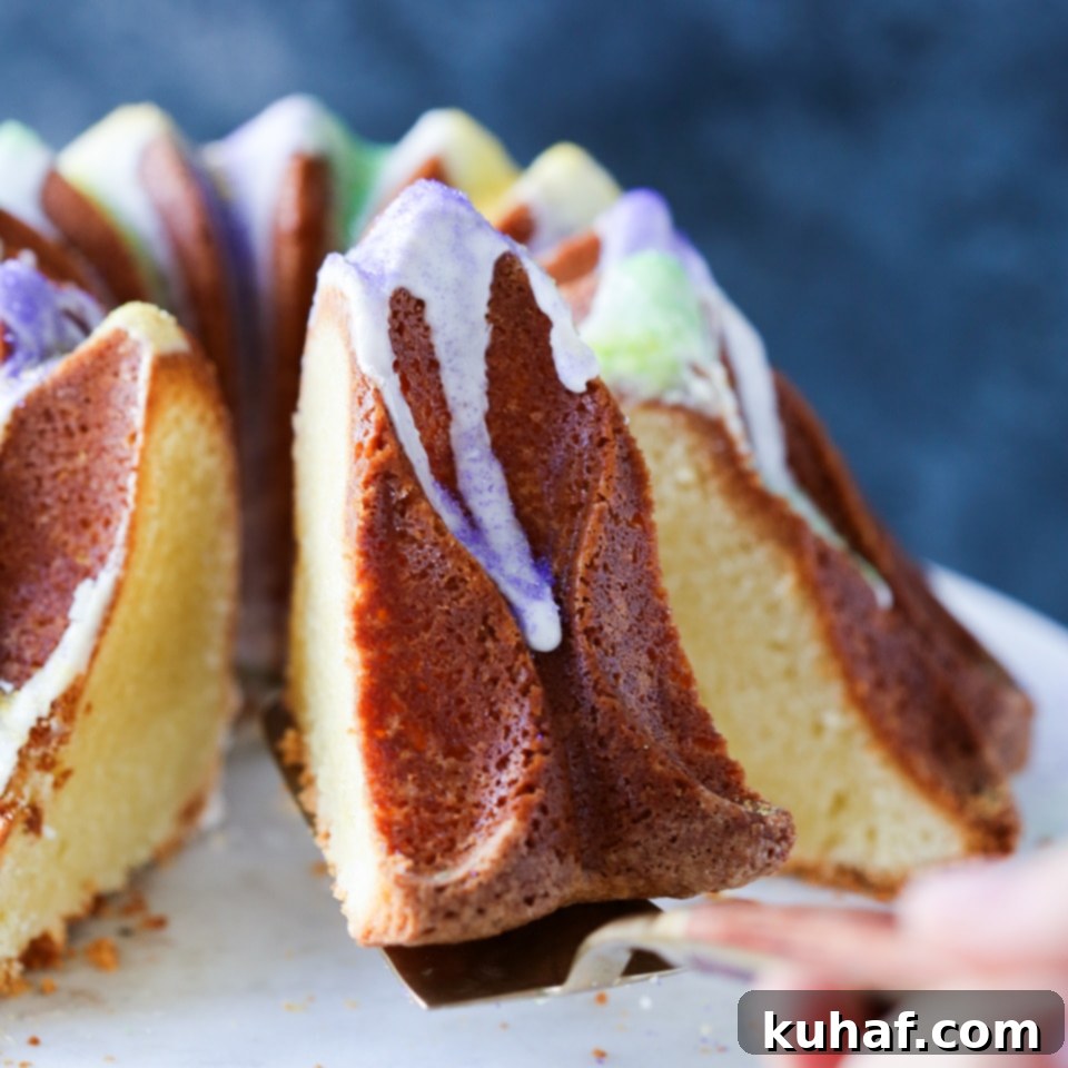 A beautifully decorated Mardi Gras King Bundt Cake with purple, green, and yellow sprinkles on a serving platter, ready to be enjoyed.