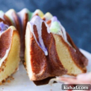 A tantalizing slice of Mardi Gras King Pound Cake being lifted from the whole cake with a server, showcasing its perfect texture and rich glaze.