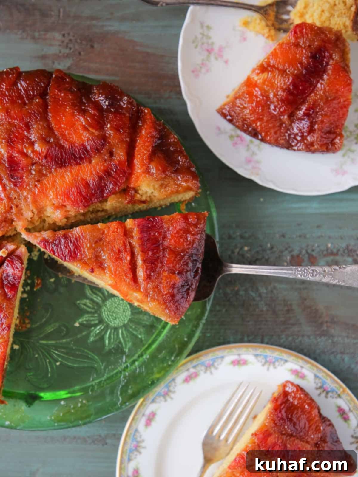 orange upside down cake on green cake plate and vintage plates.