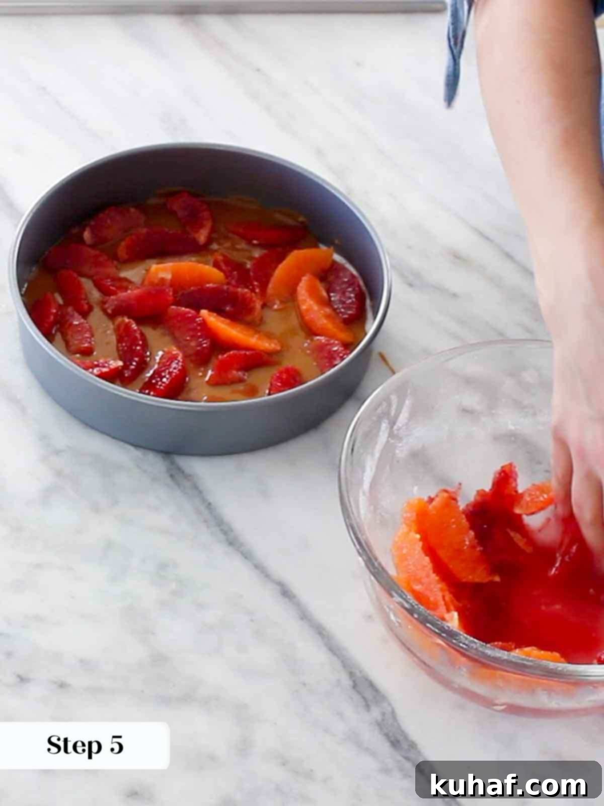 arranging orange slices in cake pan.
