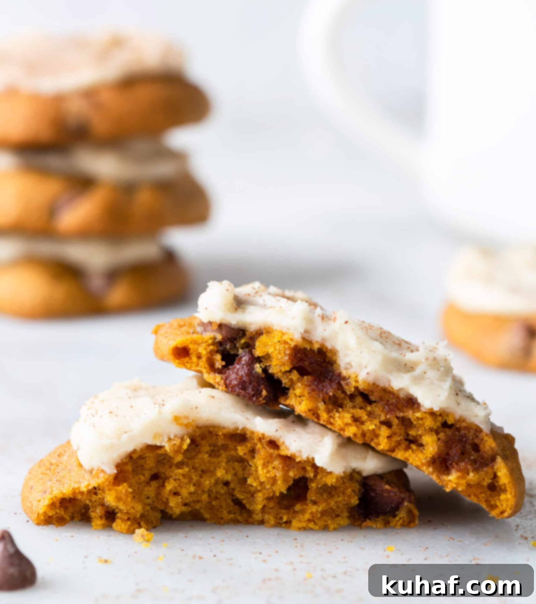 Spiced Pumpkin Chocolate Delights 3 Close-up interior view of a chewy chocolate chip pumpkin cookie with browned butter icing, highlighting the soft crumb and chocolate chips.