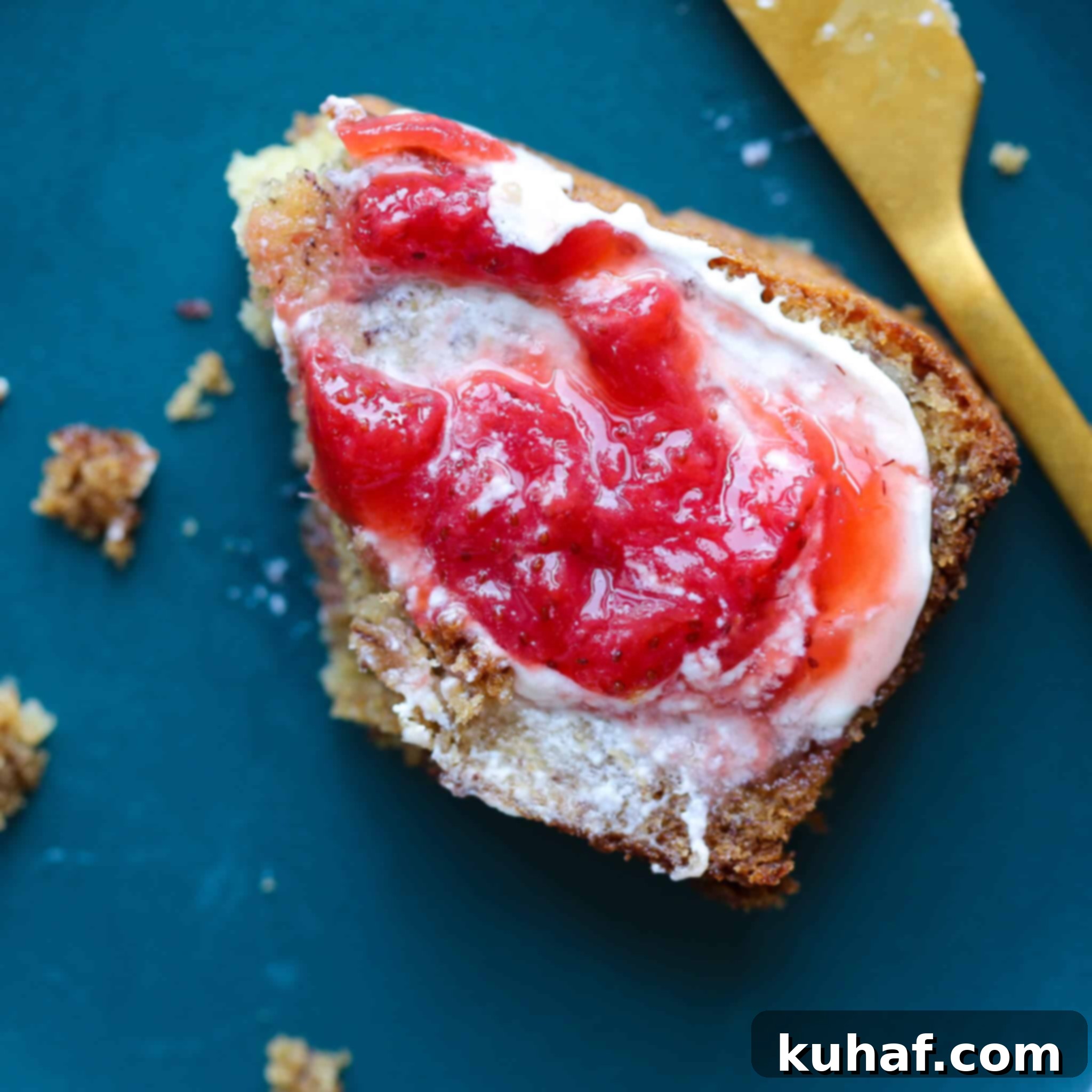 Close-up of delectable Old Fashioned Banana Bread, with one slice elegantly topped with homemade strawberry jam and creamy mascarpone, highlighting the textures.