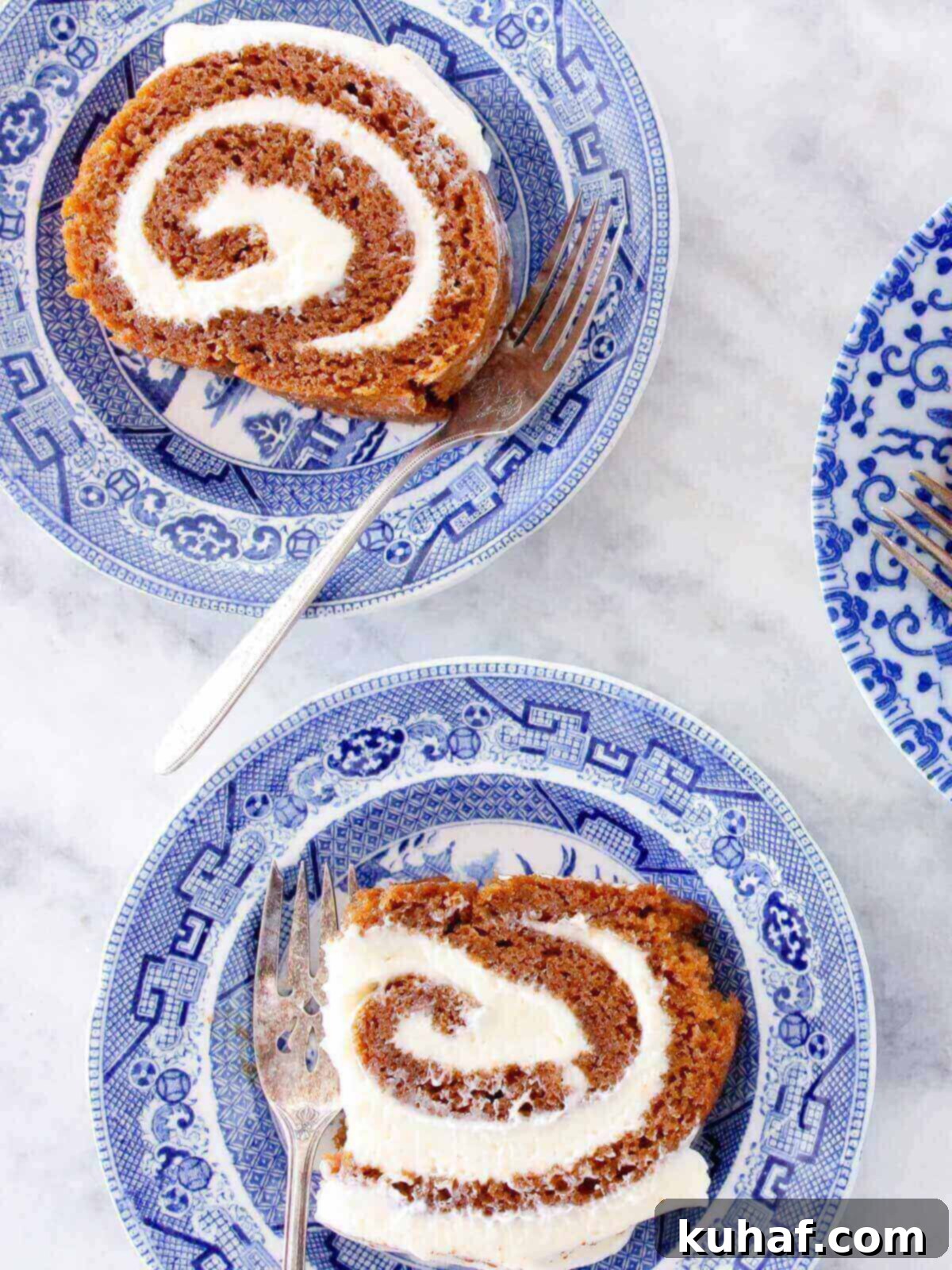 Irresistible Autumn Pumpkin Roll 2 pumpkin roll slices served being eaten.
