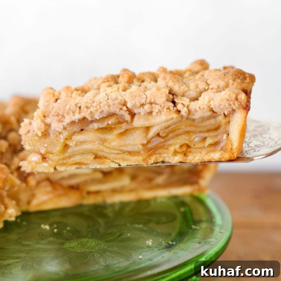 Exquisite Caramel Apple Tart with a golden cinnamon streusel topping, perfectly sliced.