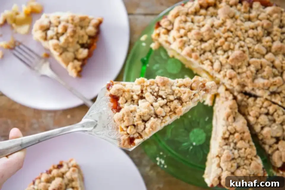 Two Caramel Apple Tarts, one whole and one with a slice removed, on a table.