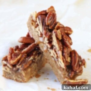 Maple Pecan Caramel Blondies leaning on parchment