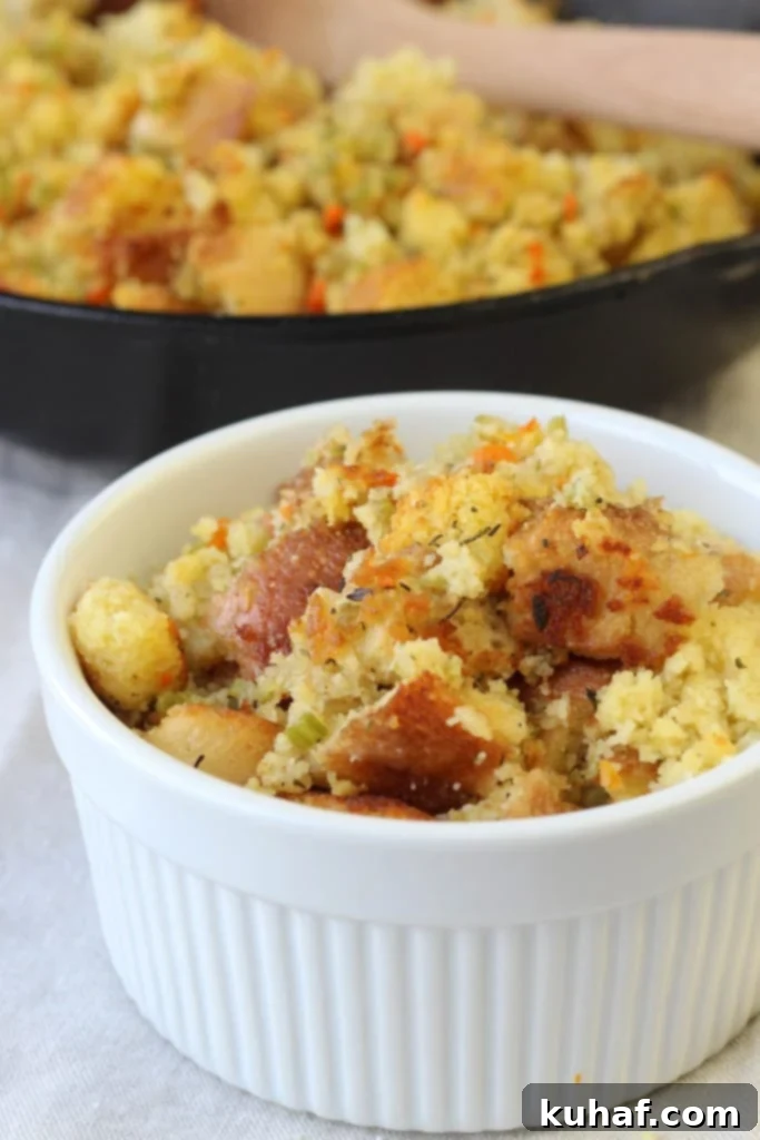 A large bowl of golden brown Classic Cornbread Stuffing, ready to be served.