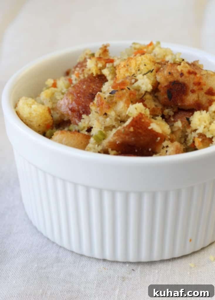 A generous serving of Classic Cornbread Stuffing on a plate, garnished with cranberries.