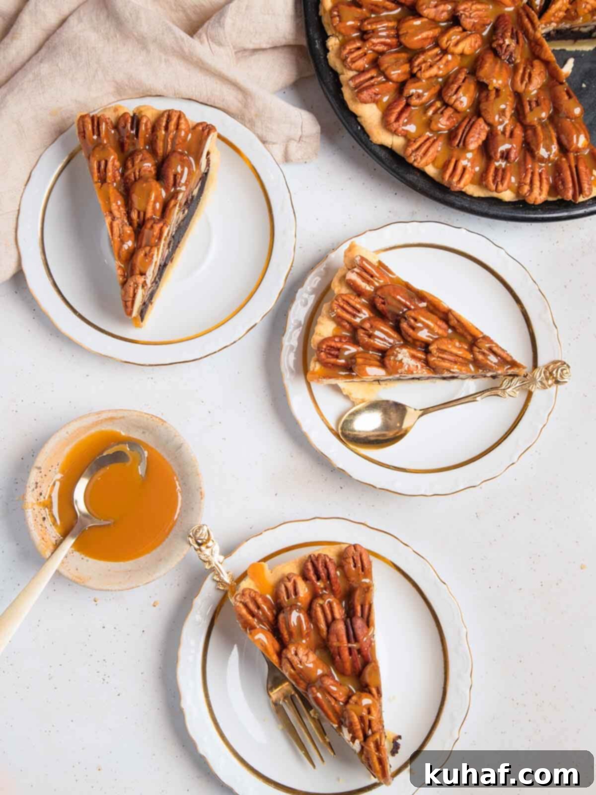 Three exquisite slices of chocolate pecan pie, rich in color, beautifully plated on a white background, showcasing the filling's texture and toasted pecans.