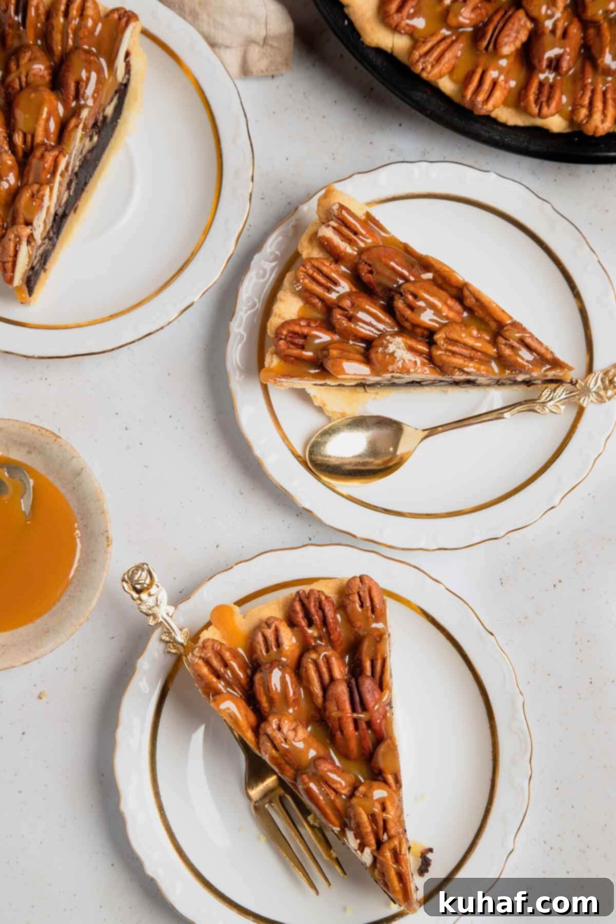 Two exquisite slices of chocolate pecan pie presented on elegant white plates, garnished with caramel drizzle and a sprinkle of sea salt.