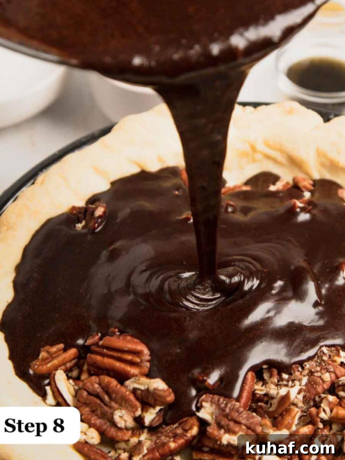 Step 8: Pouring the rich chocolate pecan pie filling into the prepared par-baked pie shell.
