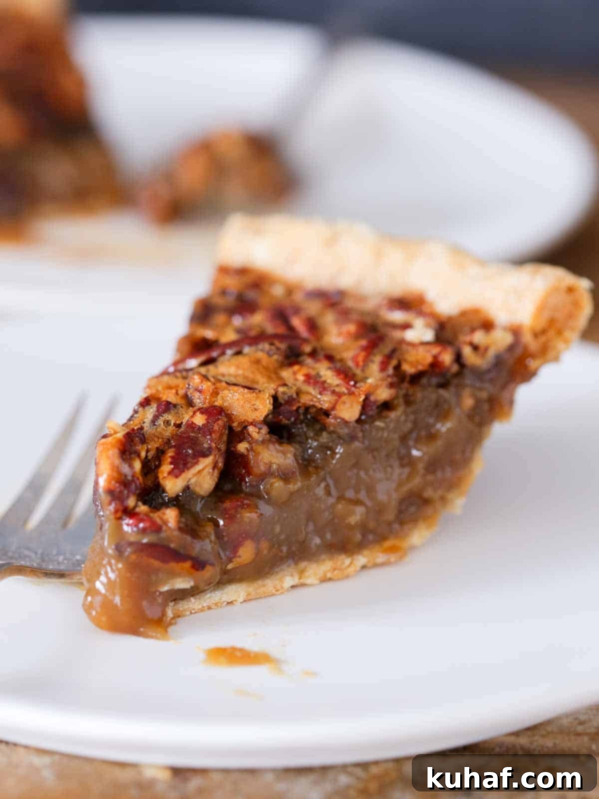 slice of pecan pie on white plate.