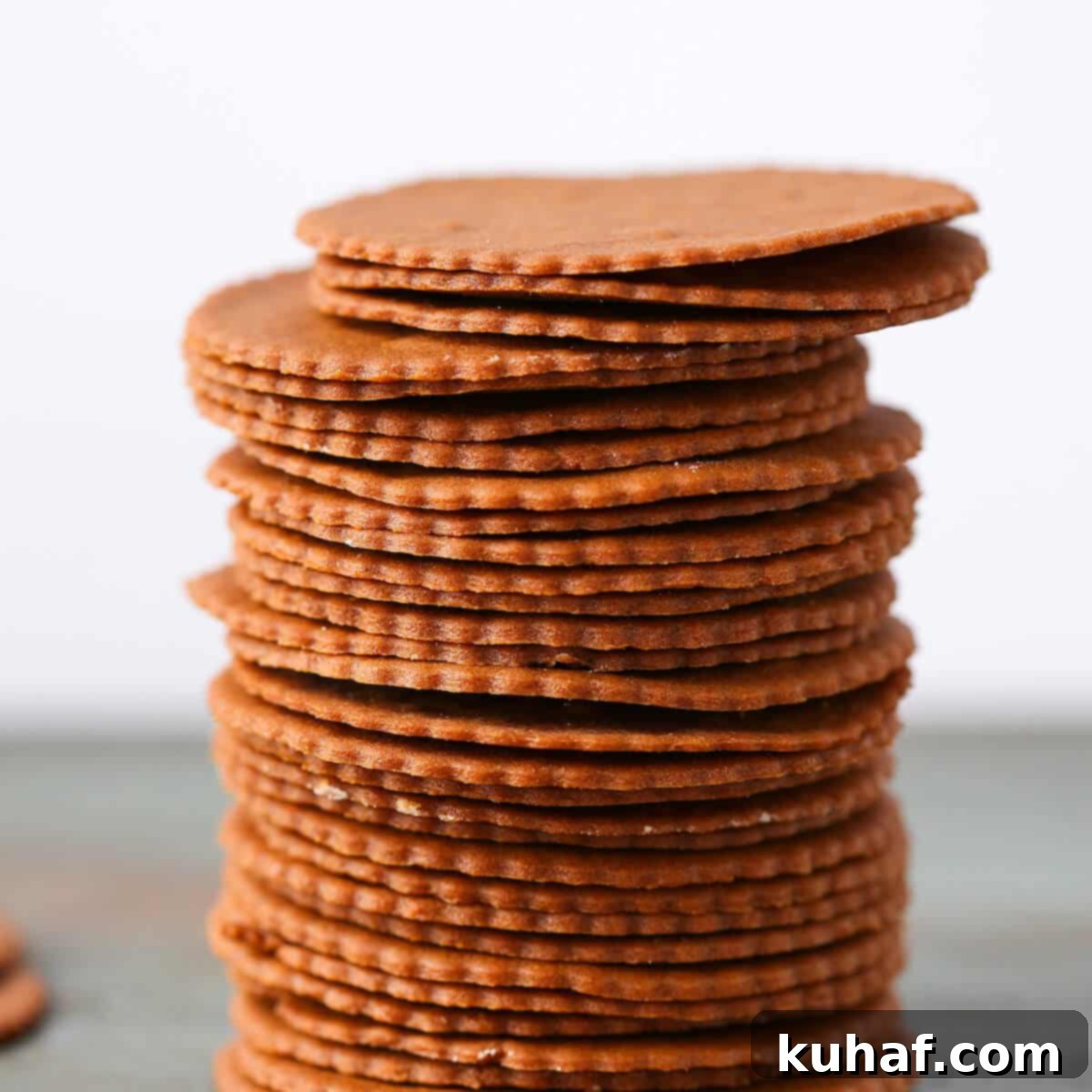 Moravian Christmas Cookies stacked tall green surface