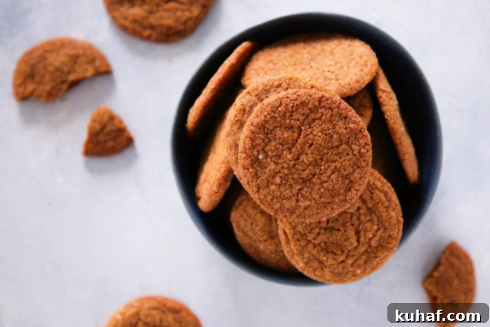 Freshly baked gingersnaps cooling on a rack.