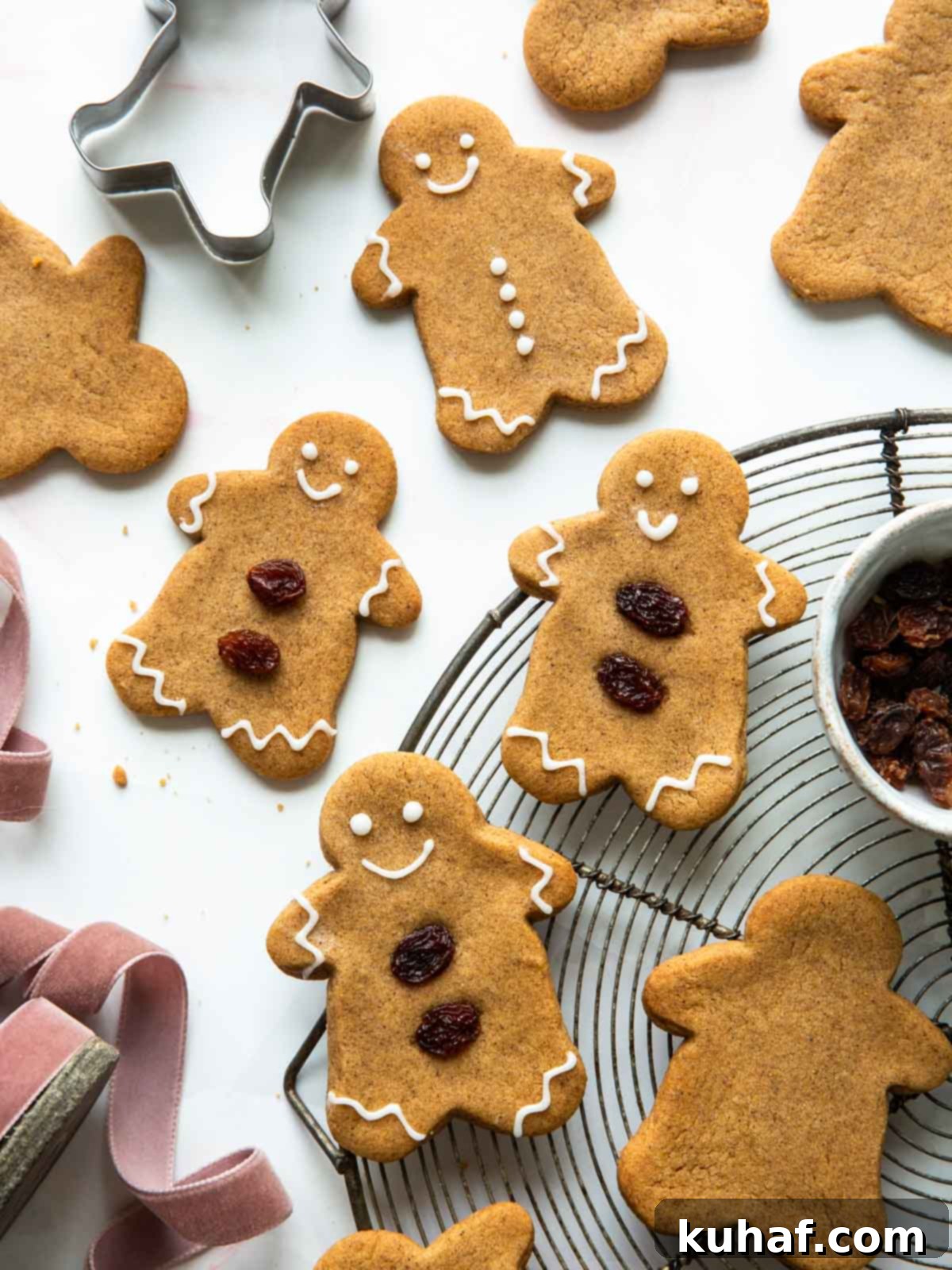 Freshly baked soft gingerbread cookies cooling on a wire rack, ready for holiday decorating.