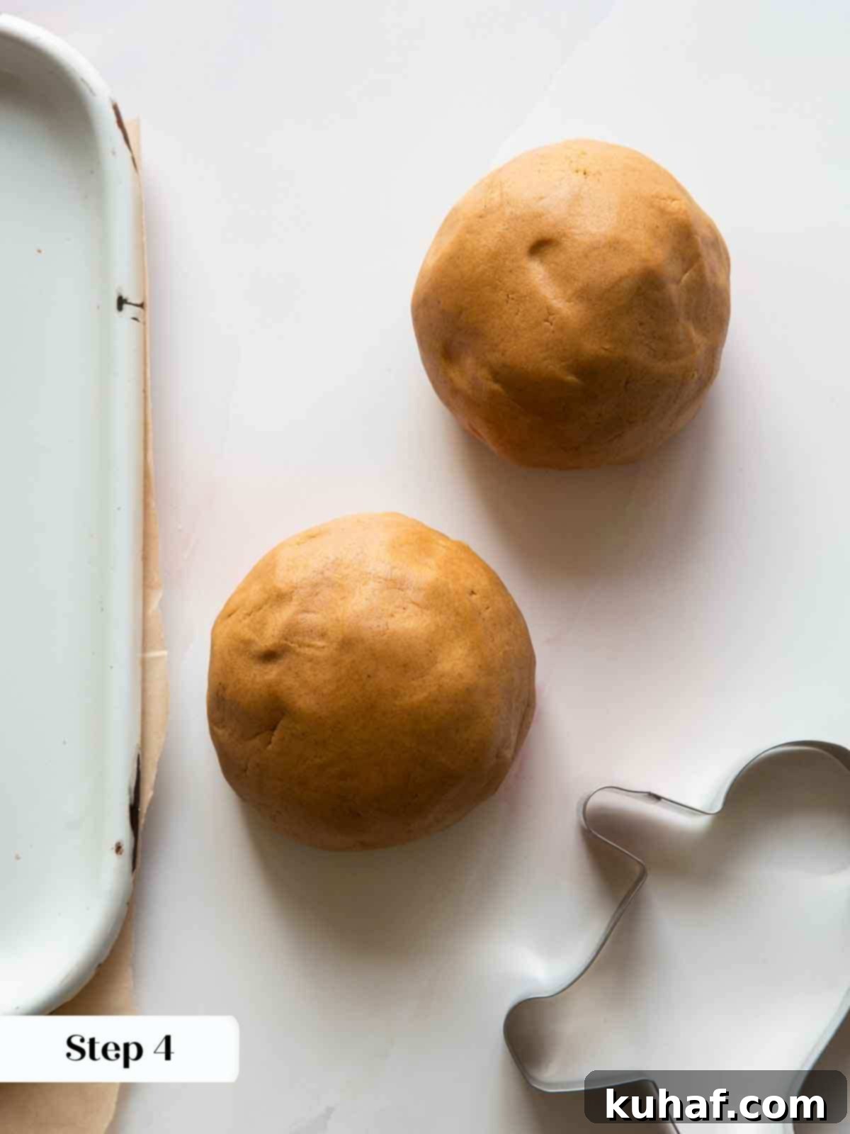 Two perfectly formed gingerbread dough balls ready for chilling and rolling.