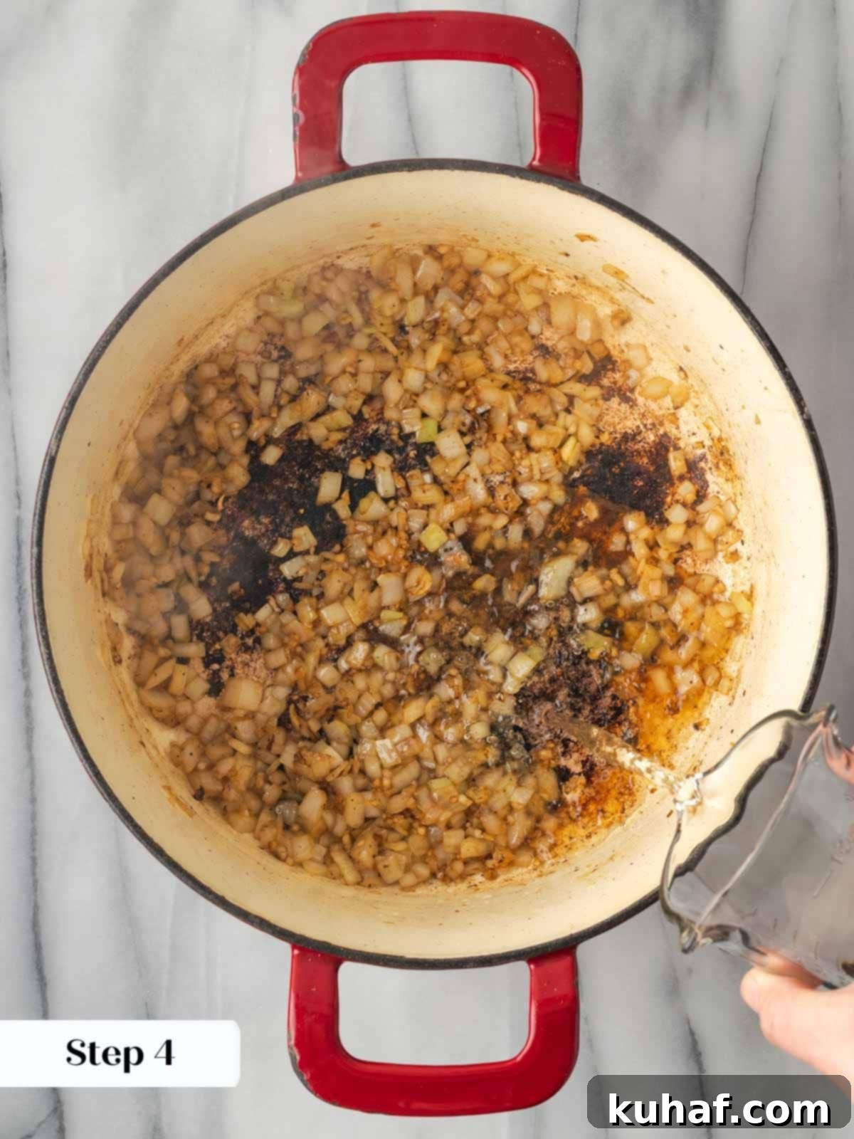 Adding wine to the pot to deglaze after browning meat.