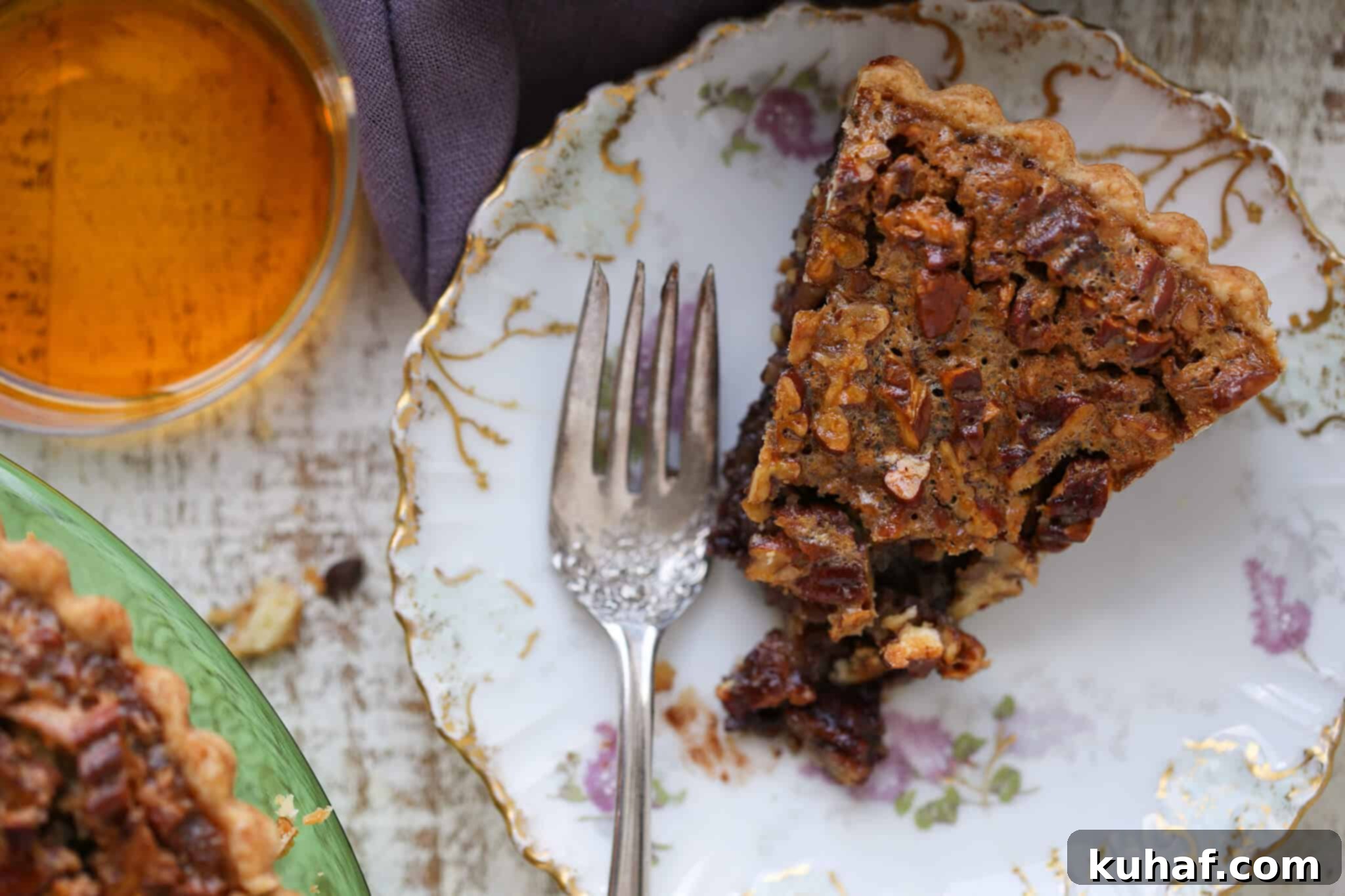 A beautiful Southern Thanksgiving Pie, possibly the Bourbon Chocolate Pecan Tart, on a plate with a vintage fork, ready to be enjoyed.