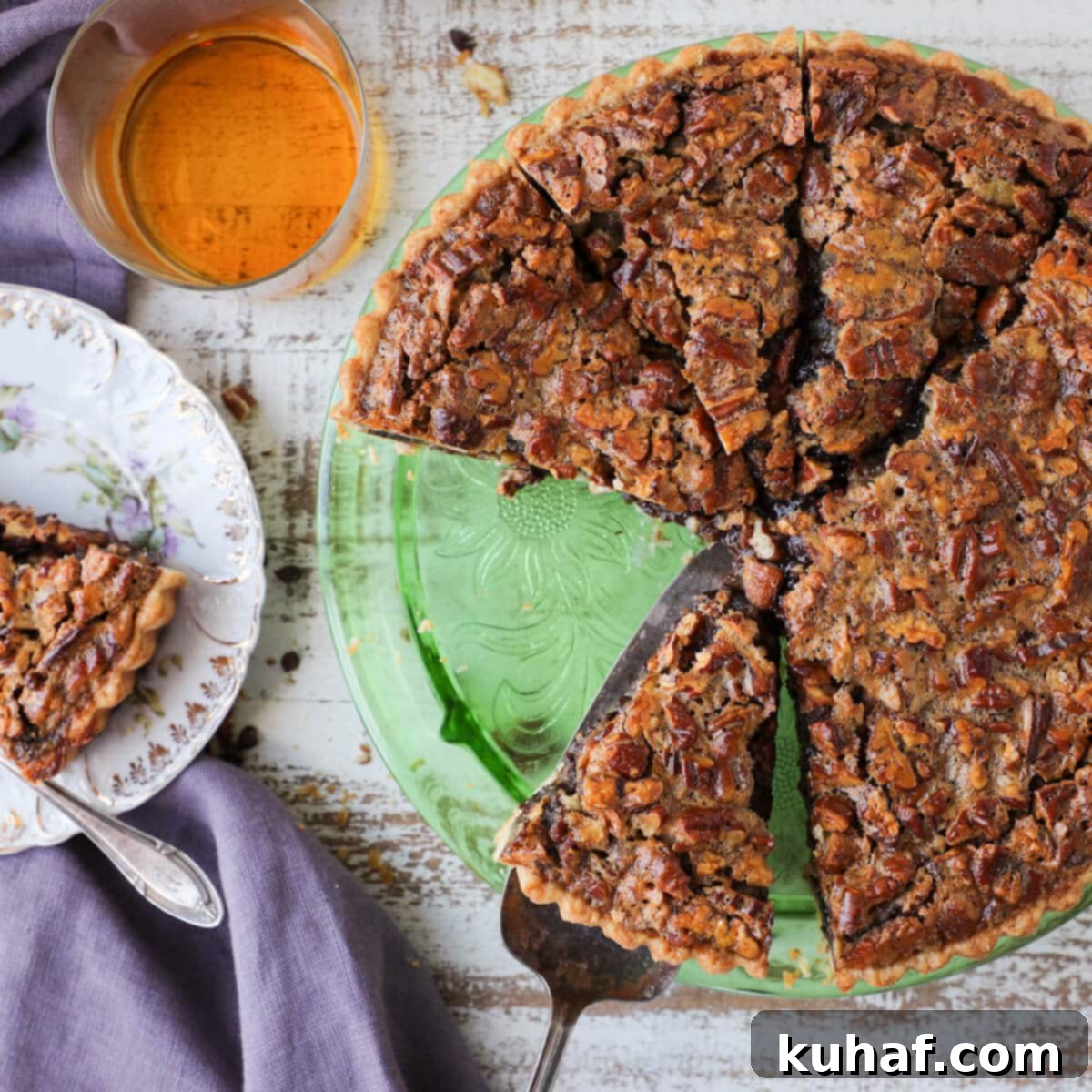 A festive Southern Thanksgiving Pie tablescape, featuring the Bourbon Chocolate Pecan Tart as a centerpiece, surrounded by other holiday dishes.