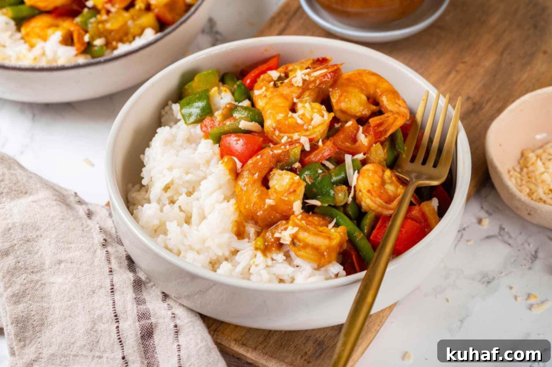Two enticing bowls of shrimp curry, garnished and ready to be enjoyed.