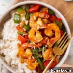 A served portion of shrimp curry with coconut rice, perfectly plated.