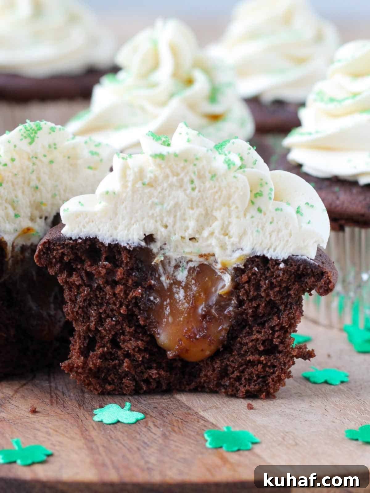 Shamrock Celebration Cupcakes 2 A St. Patrick's Day cupcake sliced open, revealing a rich Guinness chocolate cake, a gooey salted caramel filling, and a creamy Baileys buttercream topping.