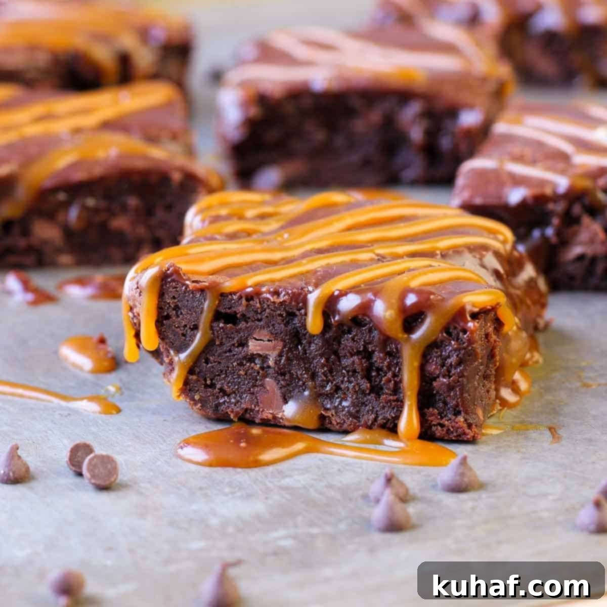 A top-down view of a pan of freshly baked, fudgy caramel brownies, with the Baileys ganache still slightly soft, showcasing the rich texture and readiness for serving.