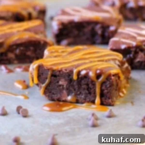A top-down view of a pan of freshly baked, fudgy caramel brownies, with the Baileys ganache still slightly soft, showcasing the rich texture and readiness for serving.