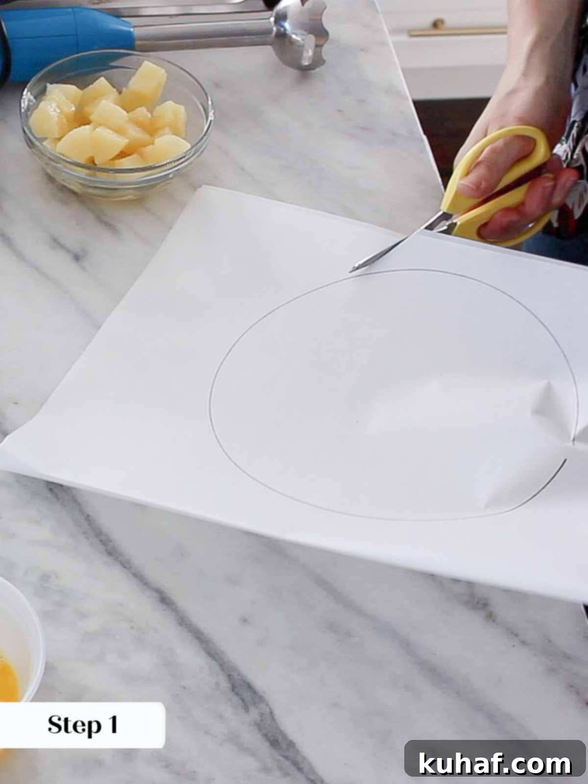 A baker carefully cutting parchment paper circles to line cake pans, ensuring a clean release.