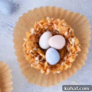 Overhead view of several coconut white chocolate nests, some filled with small pastel candy eggs.