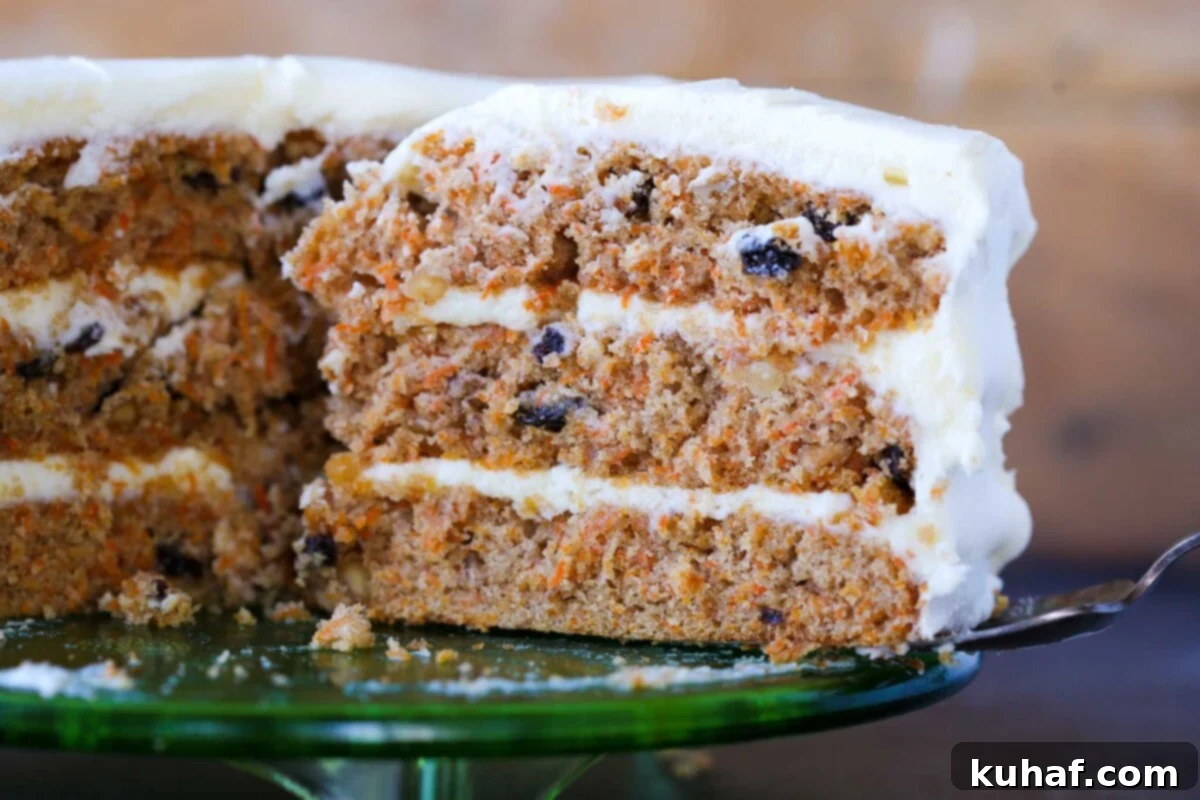 The fluffy, moist interior of a perfectly baked easy carrot cake, showing off carrots and nuts.