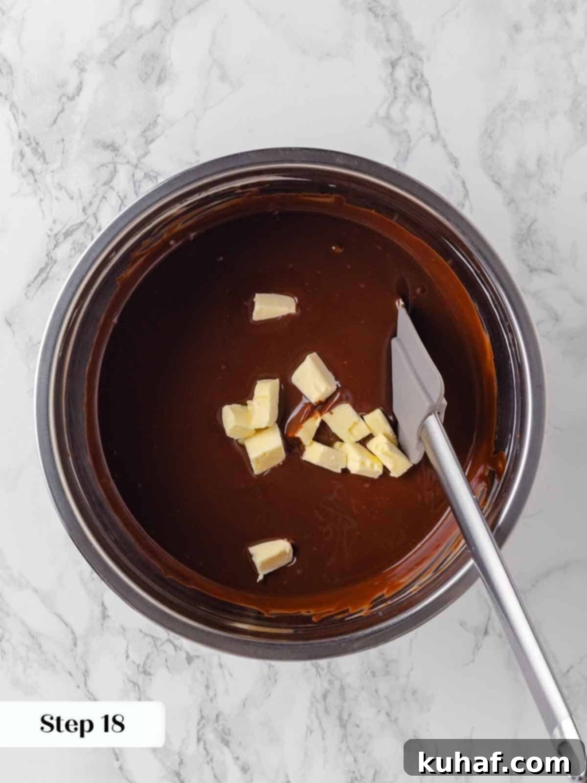 adding butter to hot ganache for frosting.