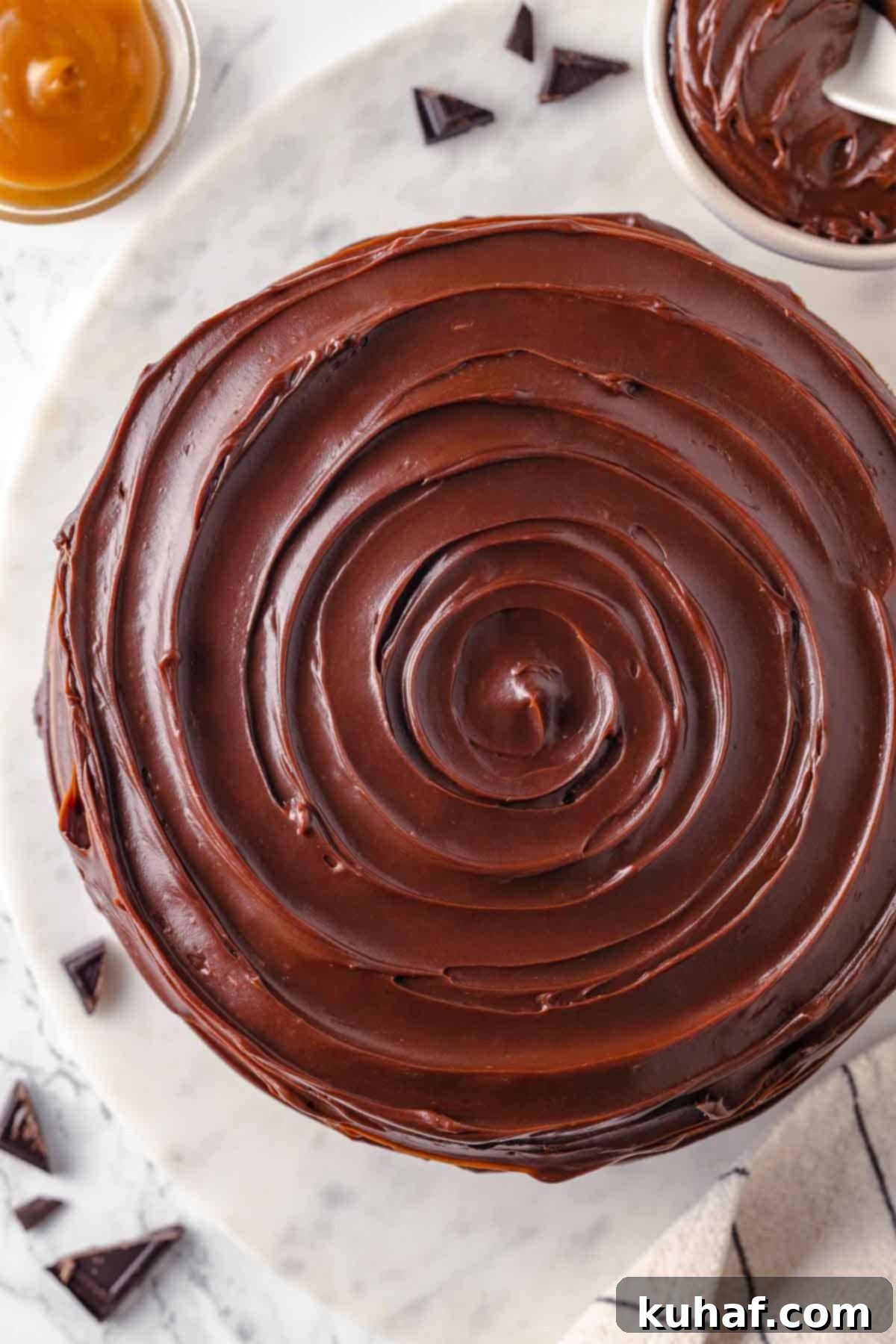 swirled caramel fudge frosting on guinness chocolate cake unsliced.
