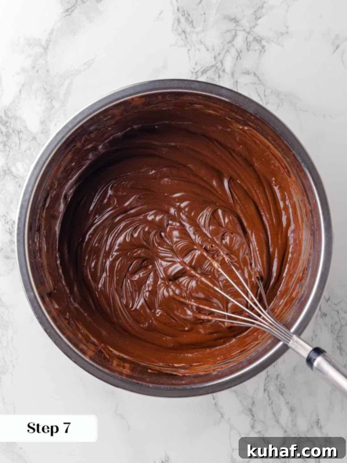 whisking in sour cream to guinness ganache mixture for cake batter.