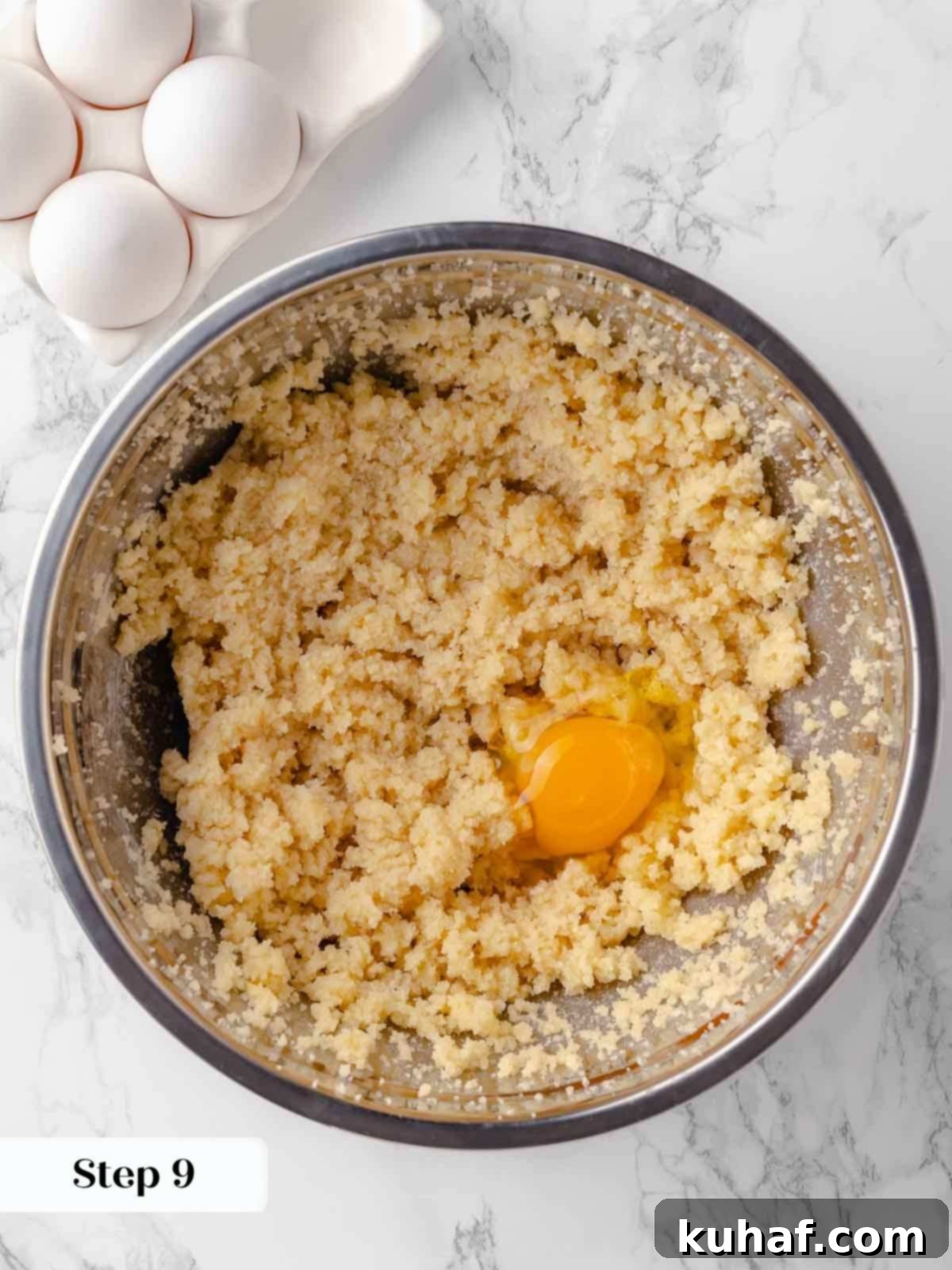 adding eggs to creamed butter and sugar for guinness cake.