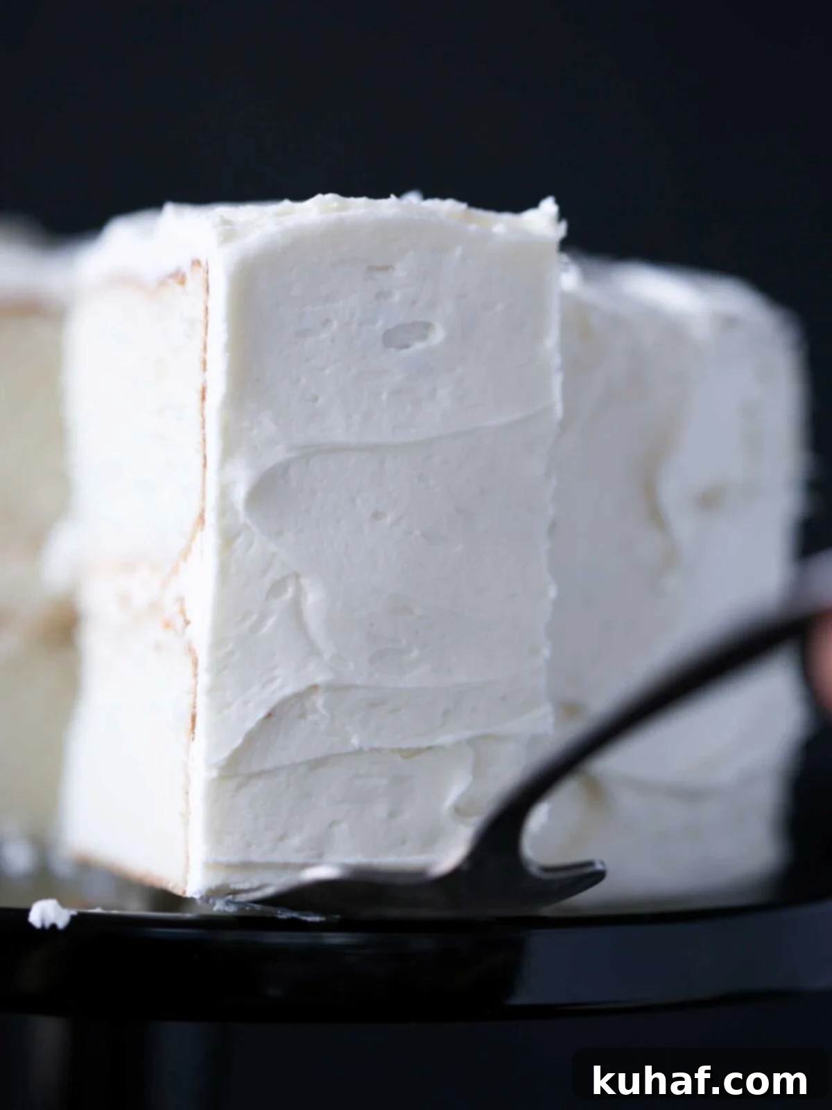 classic white cake on a cake server.