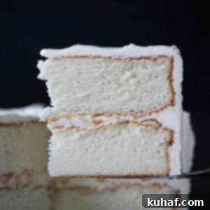 a slice of two layered white cake with frosting.