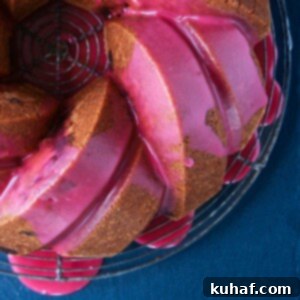 Cherry Almond Pound Cake with pink cherry glaze dripping down