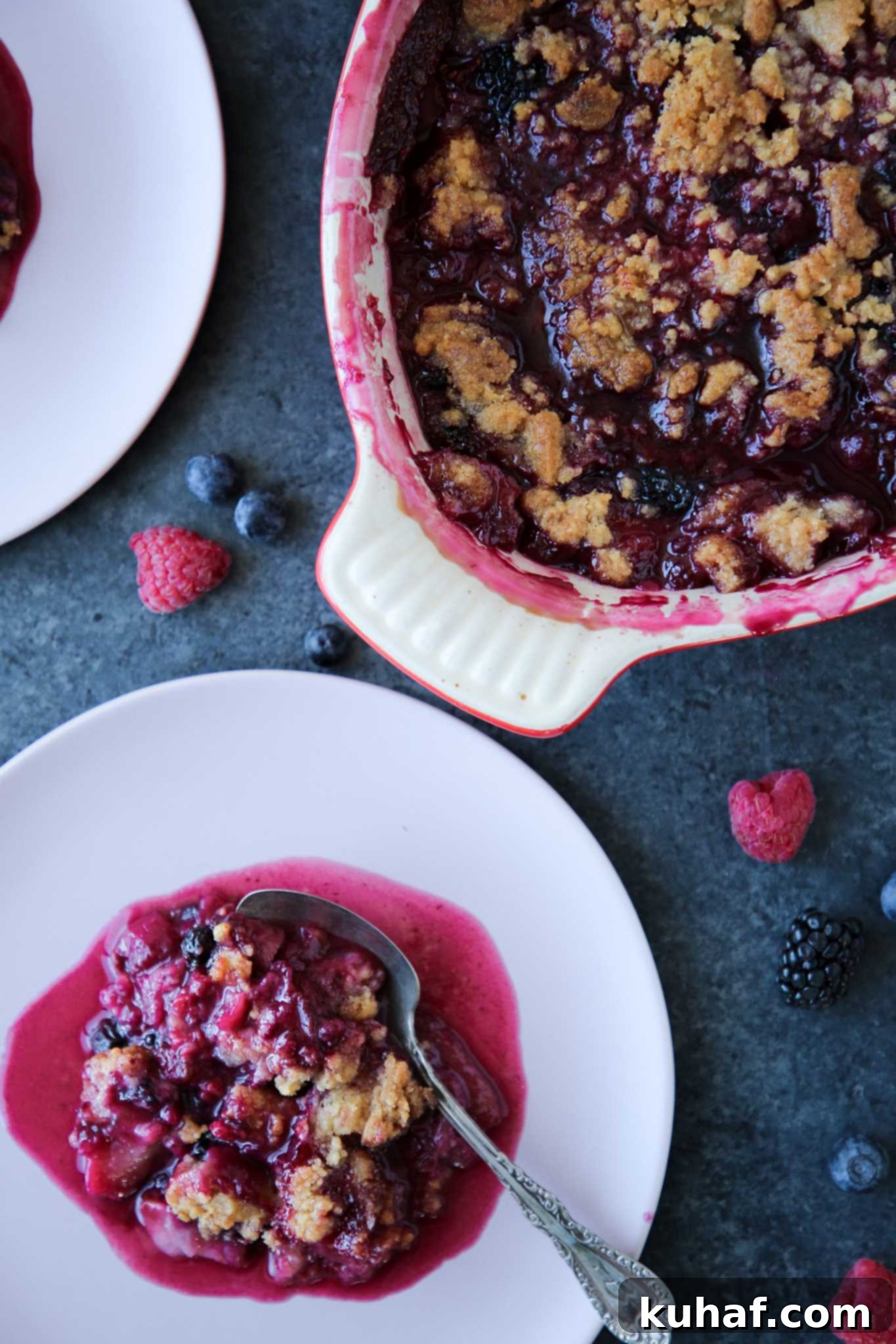 Delicious Berry Crumble 2 Berry crumble in white baking dish on blue background.