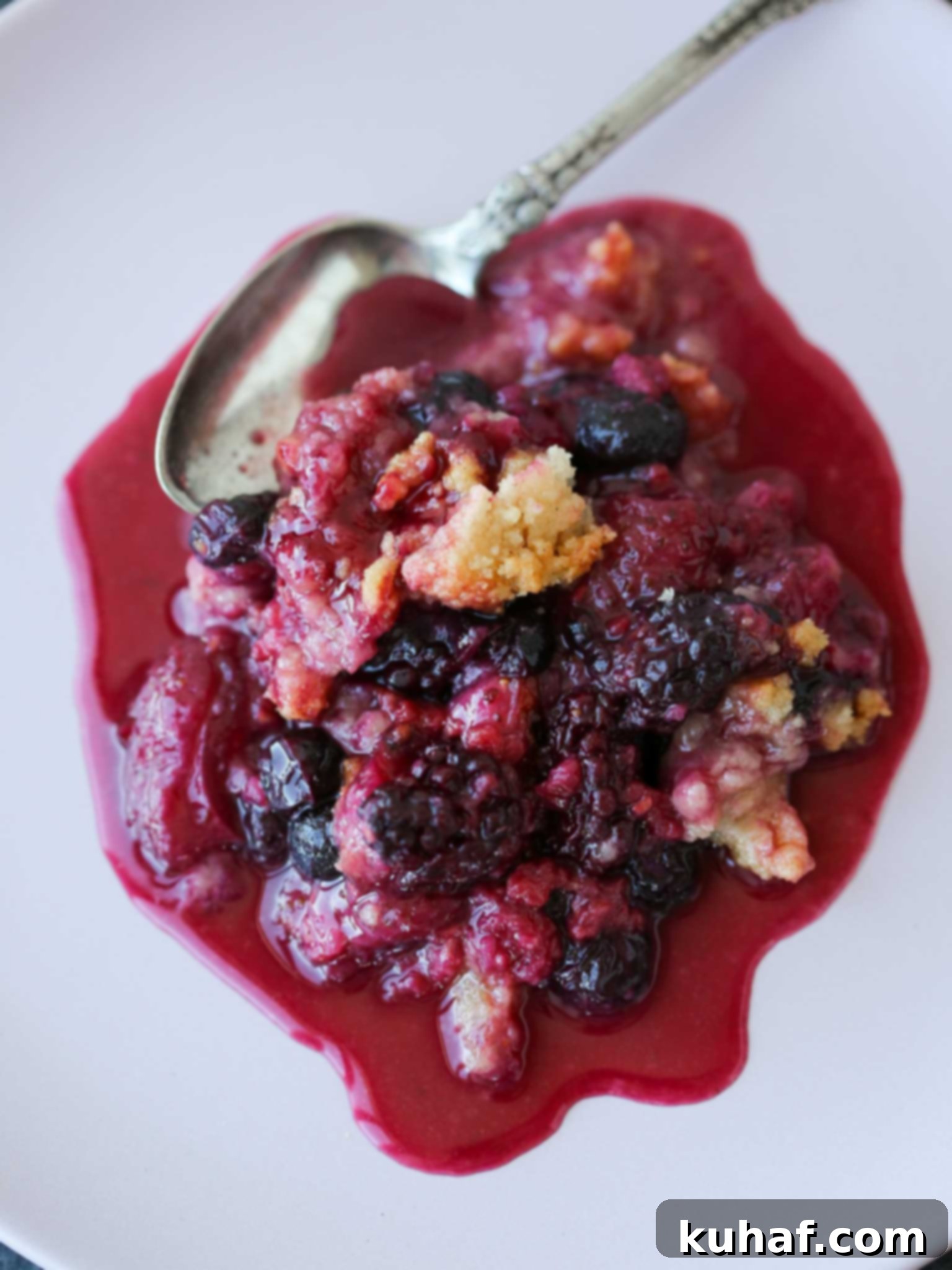 Delicious Berry Crumble 3 Mixed berry crumble served on a white plate.