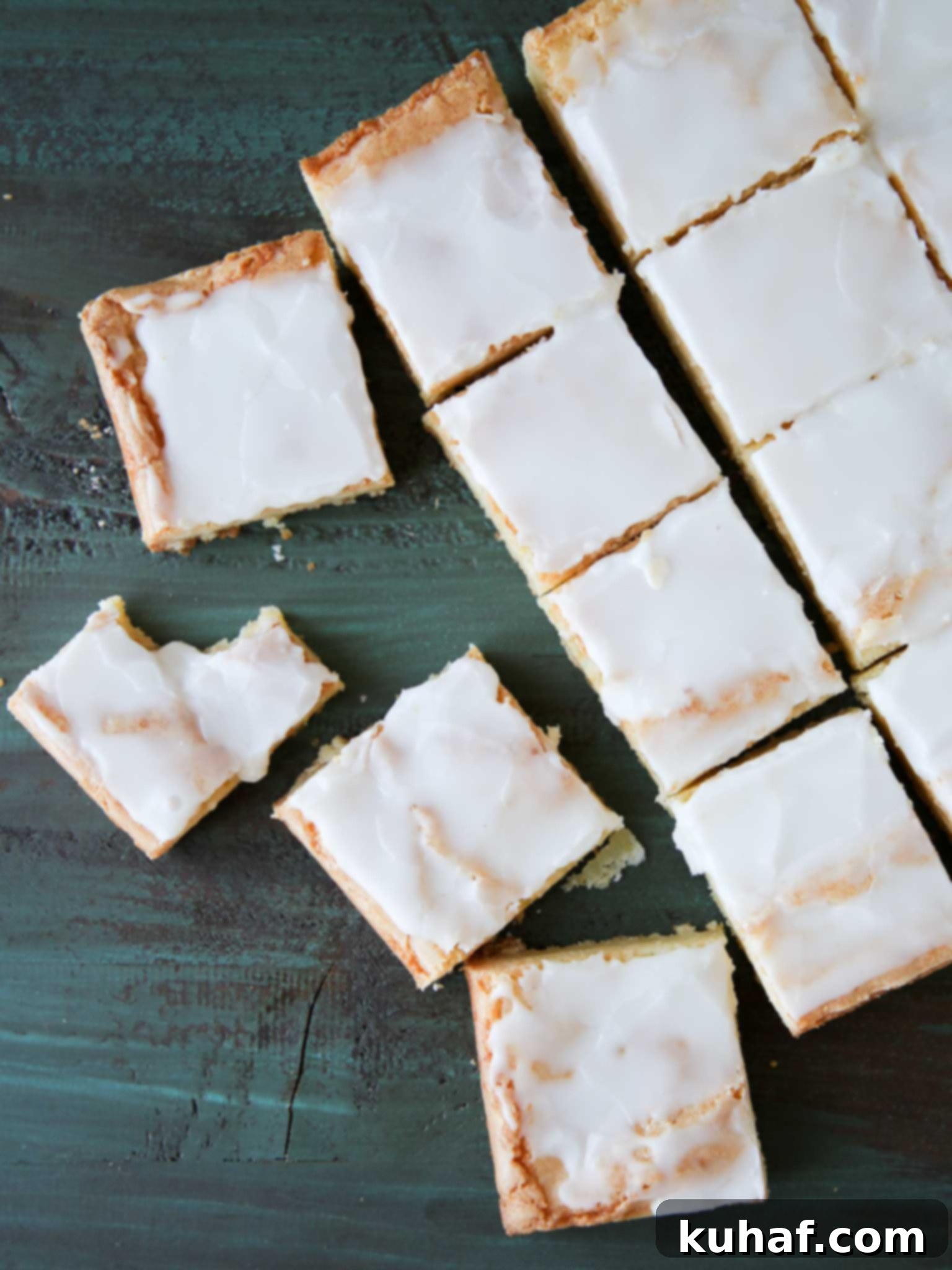 Freshly sliced Lemon Blondies arranged neatly on a serving platter, showing off their perfect square shape and inviting glaze.