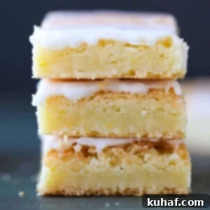 Trio of Lemon Blondies beautifully arranged, showcasing their golden hue and inviting glaze, ready to be enjoyed.
