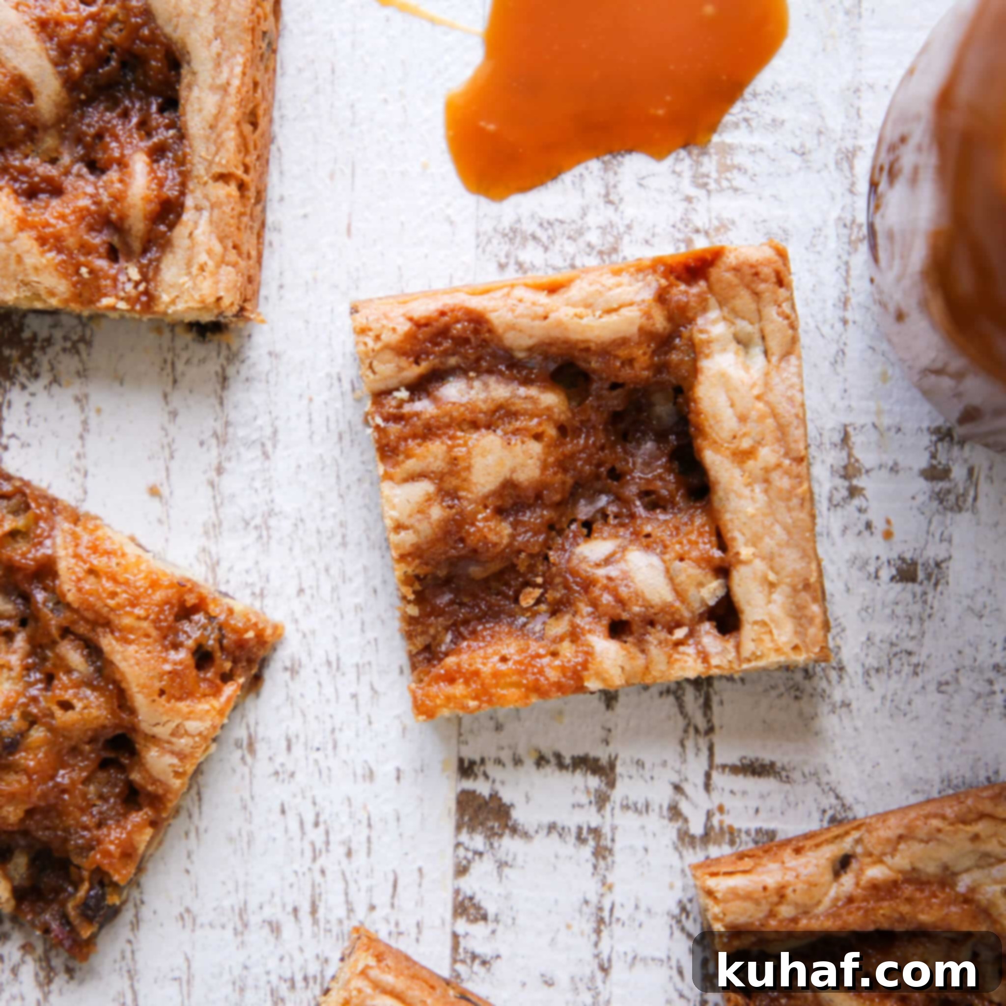Caramel Chocolate Chip Blondies sliced on white wooden board
