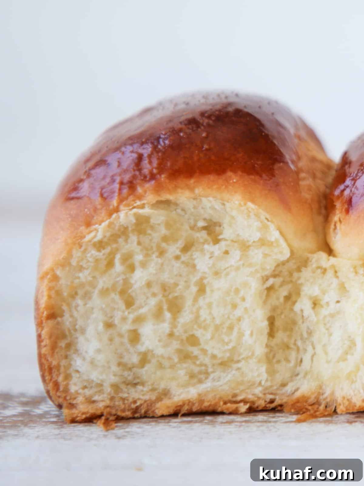 Interior view of a soft, fluffy easy dinner roll, showing its open crumb texture