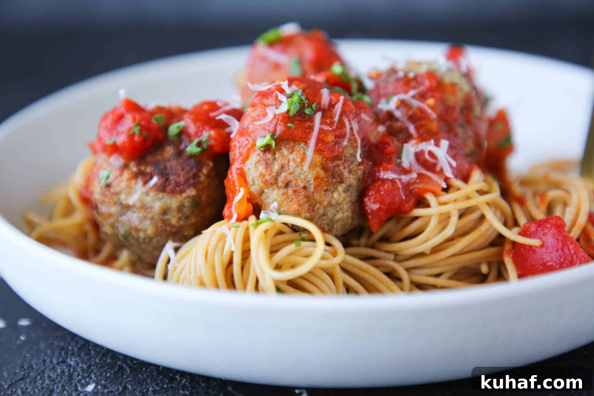 Baked turkey meatballs served in a white pasta dish, ready to eat.
