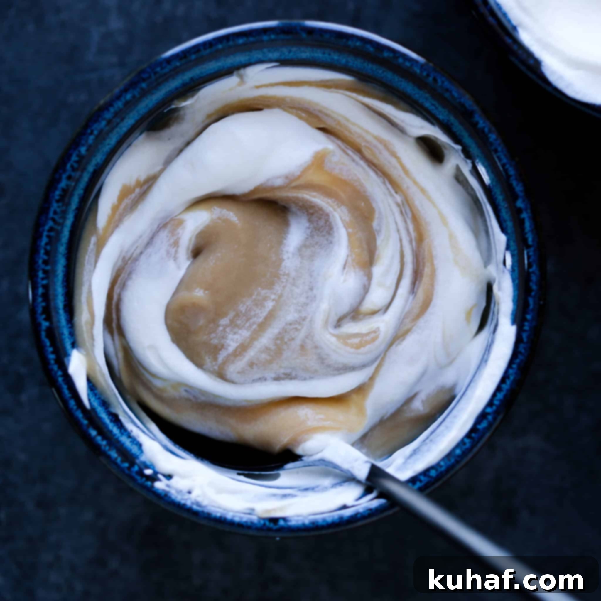 Light brown butterscotch pudding swirled with white whipped cream.