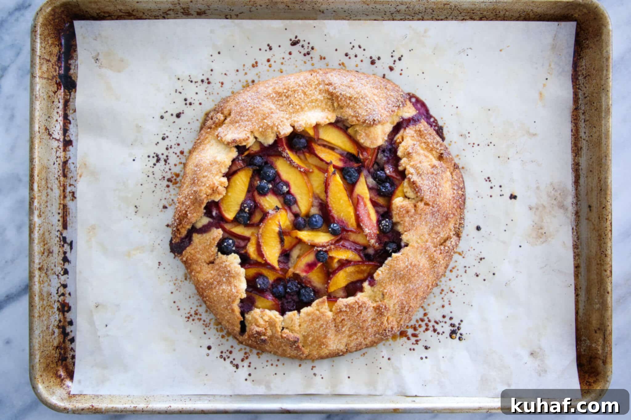 An unbaked Blueberry Nectarine Galette on parchment paper, ready for the oven.