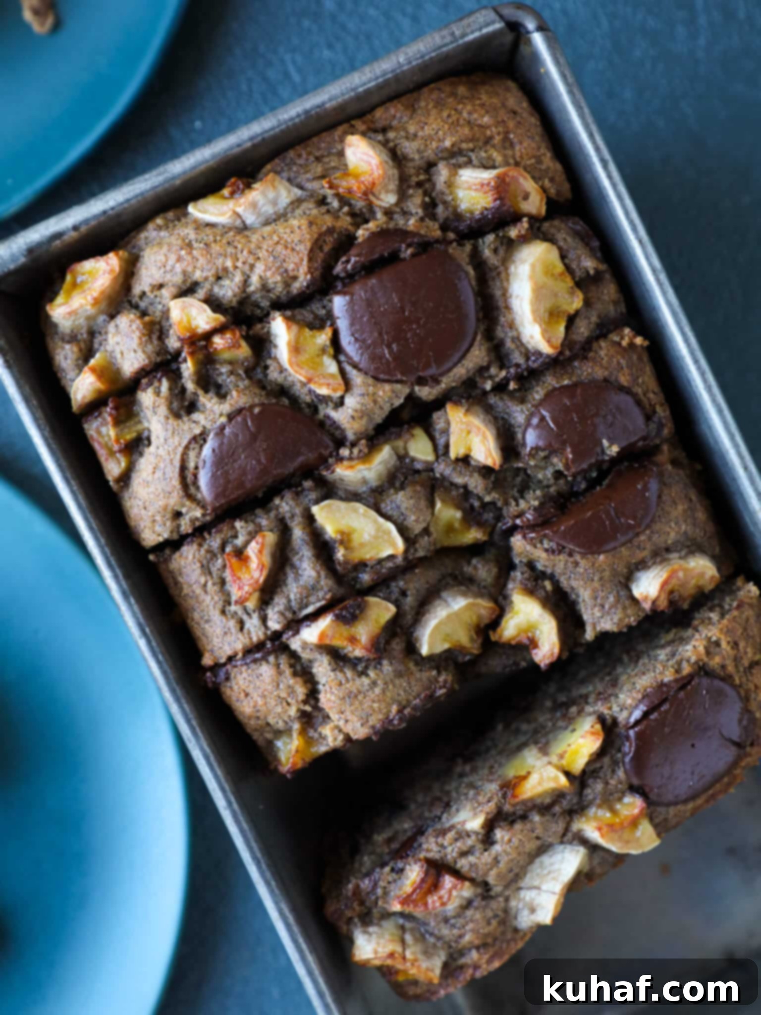 Slice of incredibly moist vegan chocolate chip banana bread with buckwheat flour, showing a tender crumb and melted chocolate chips