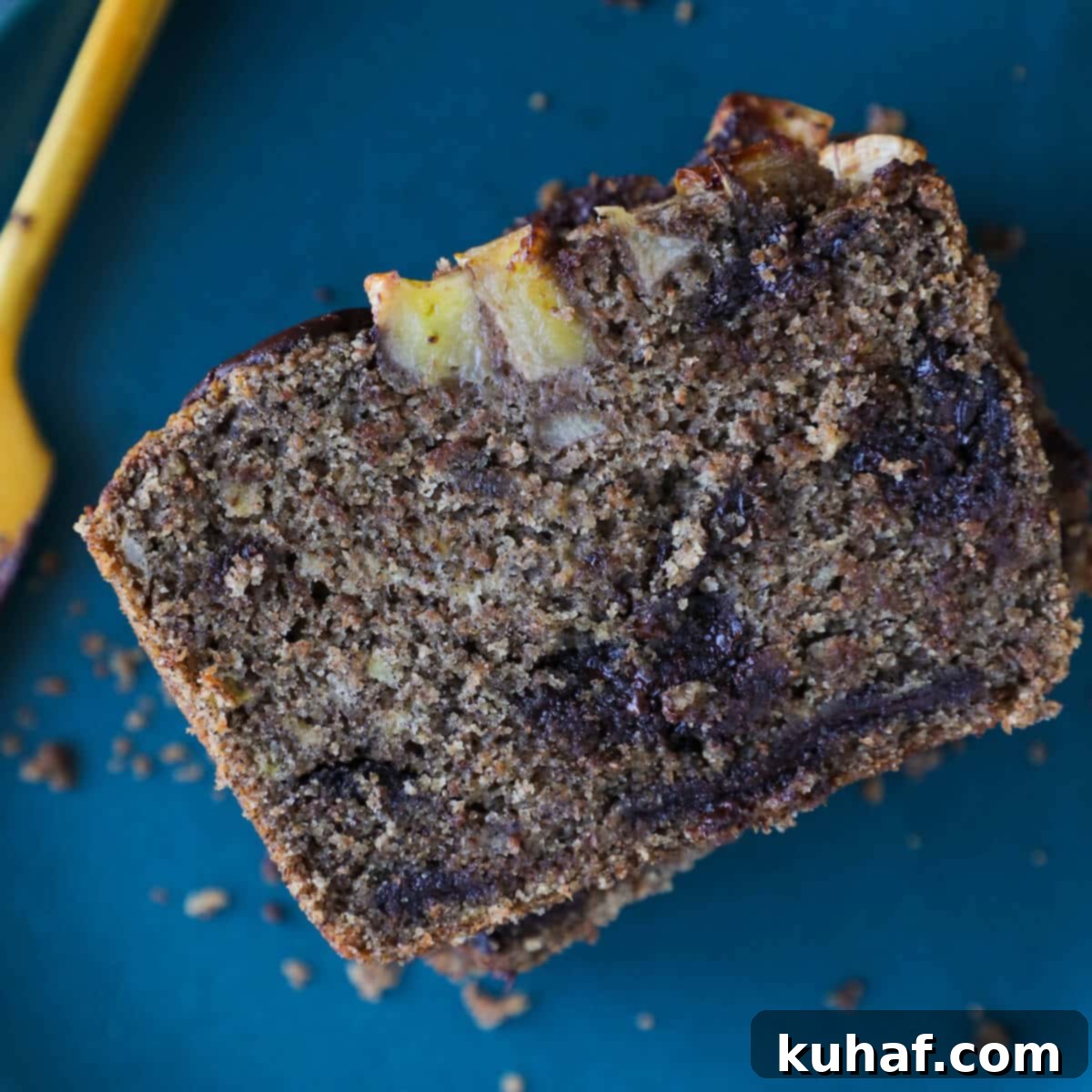 Crumb shot of vegan gluten-free chocolate banana bread cooling on a wire rack, highlighting its delicate, tender texture