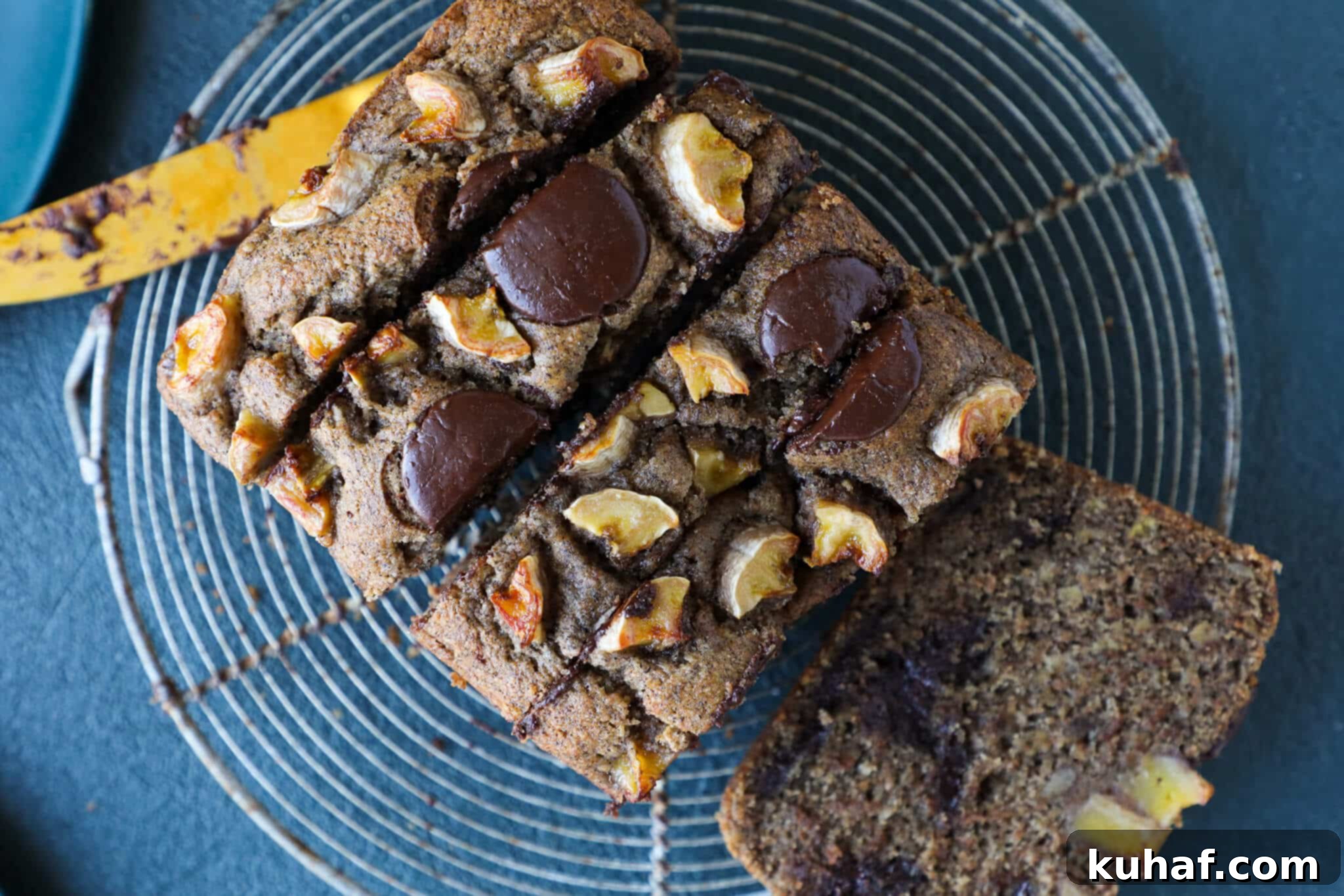 Freshly baked vegan chocolate chip banana bread cooling on a wire rack, showcasing its golden-brown crust and inviting aroma